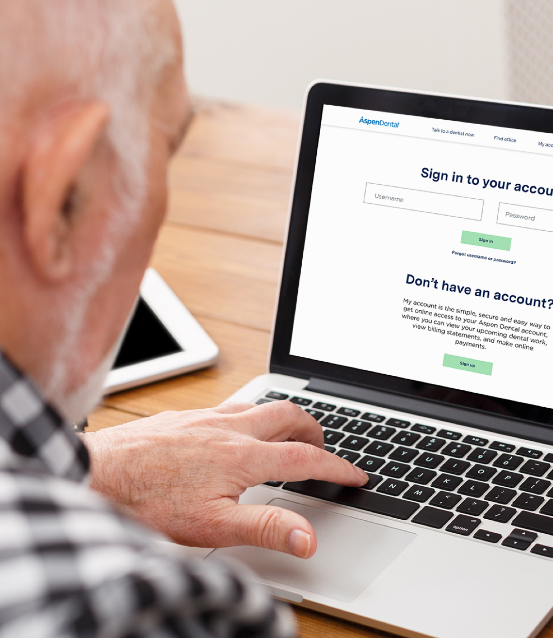A man is signing up for an Aspen Dental account to access his treatment plan and billing statements.
